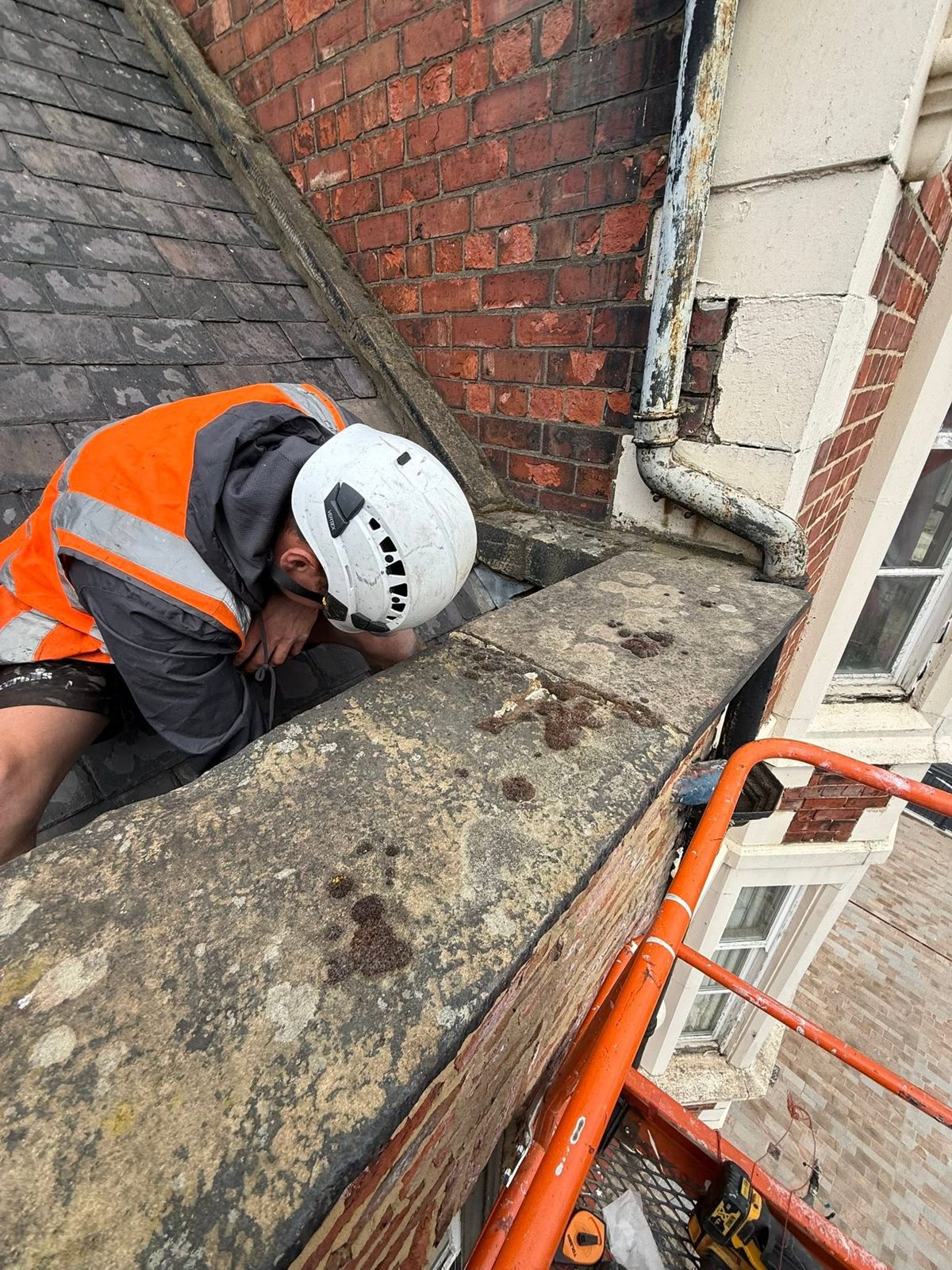 IGM operative in hi-vis and helmet working at height on a commercial building in Stockton