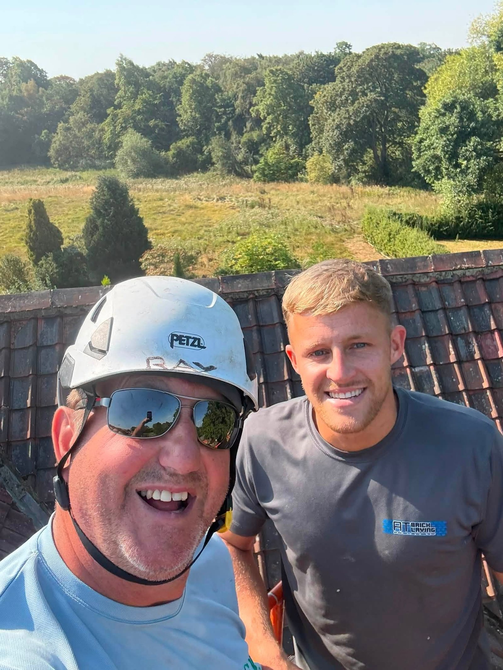 The IGM team in branded shirts and hard hats on a commercial roof in Teesside